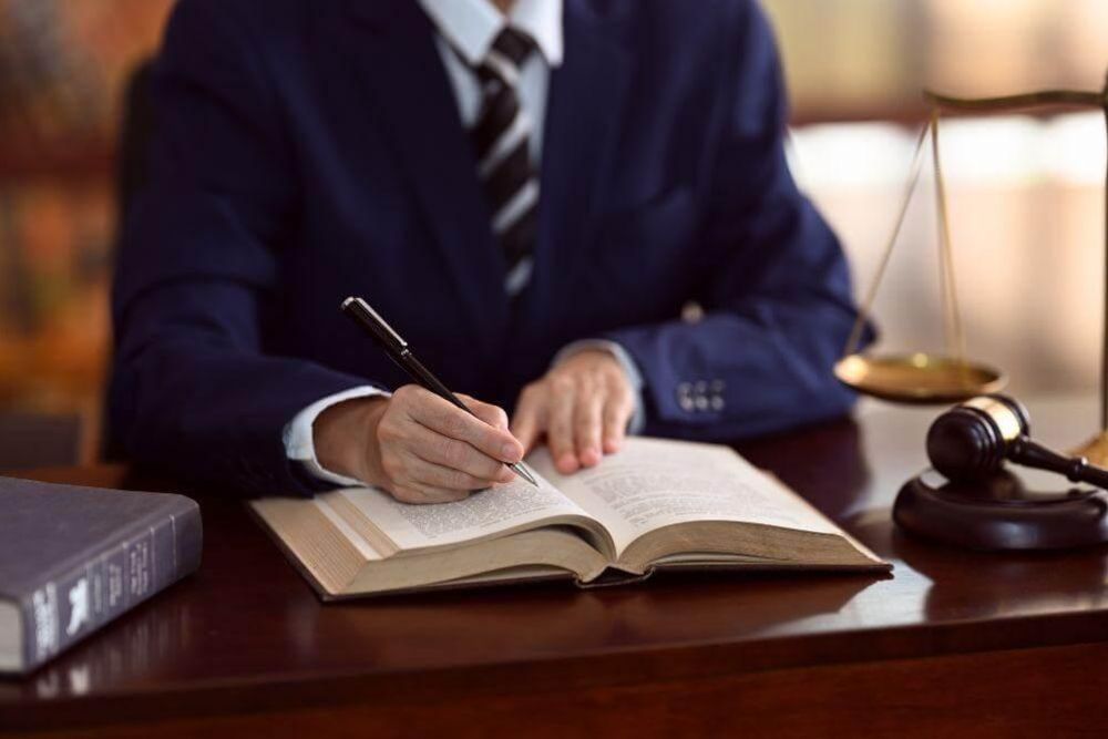 Man in suit reviewing documents at a desk