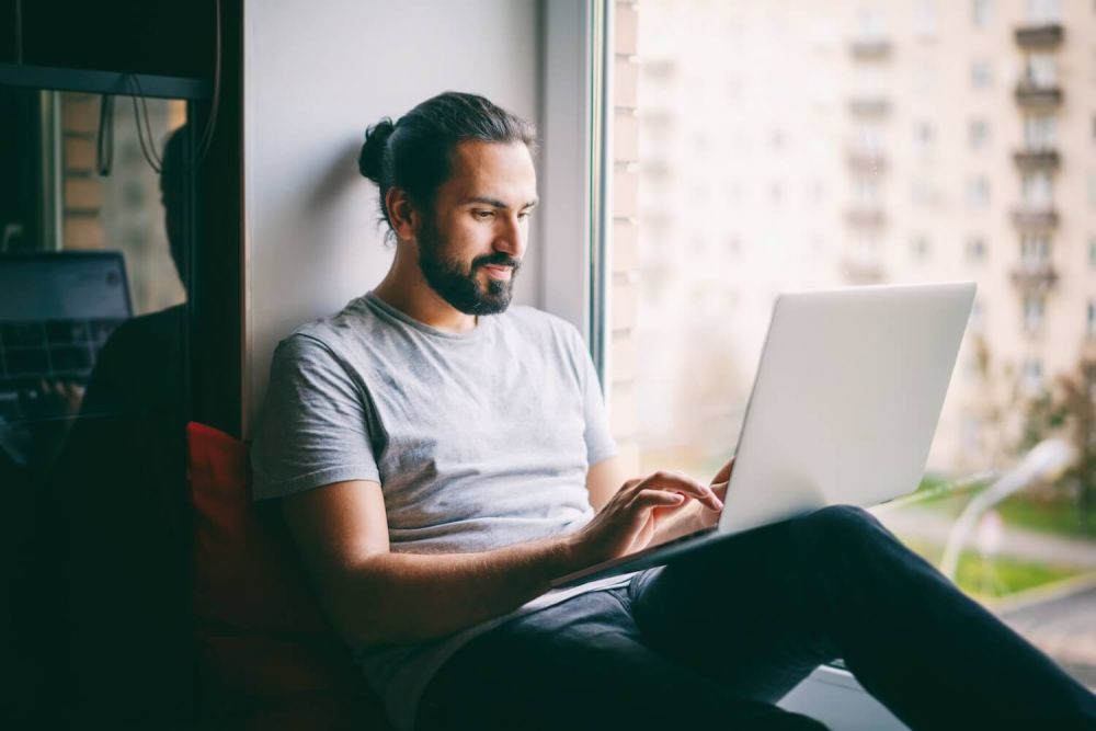 man on computer committing a cyber crime