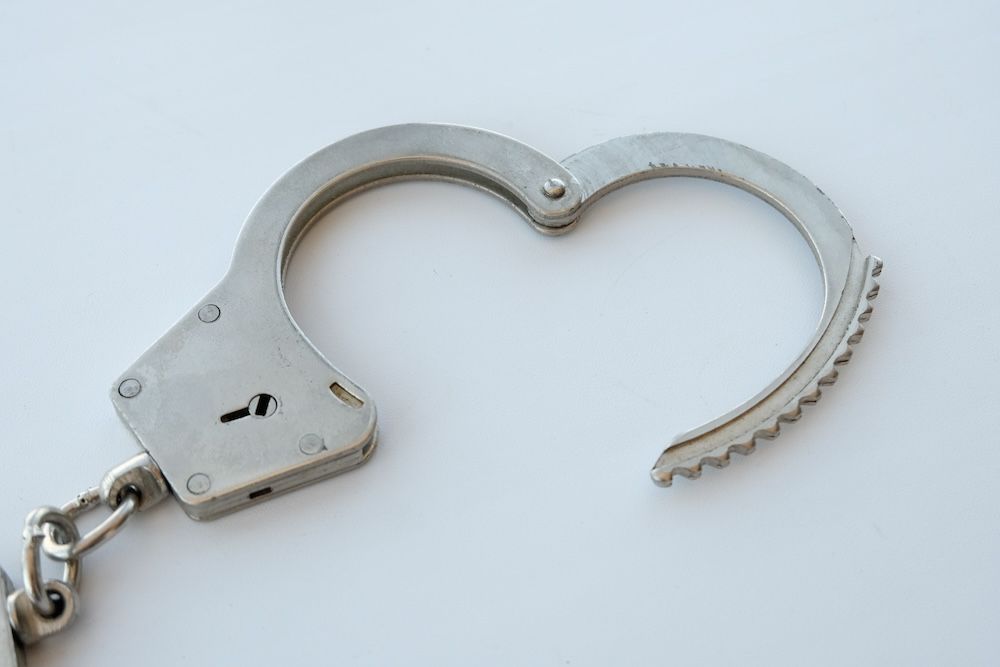 Close-up of a single handcuff shaped like a heart, symbolizing the complex and intertwined emotions involved in parole violations in New Jersey