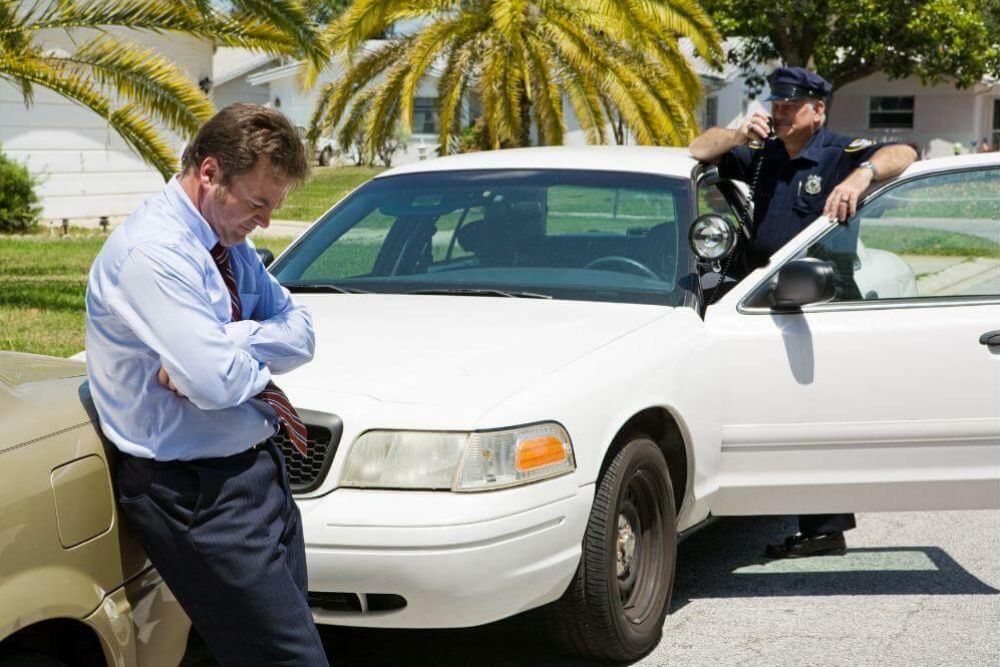 Police officer next to a white police car in New